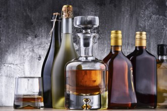 Composition with carafe and bottles of assorted alcoholic beverages
