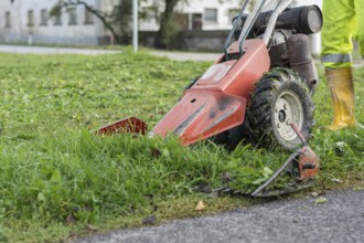 Farmer mowing grassland with motorised mower, Austria
