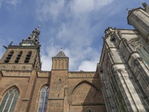 Gothic church tower and façade against a blue sky, nijmegen, the netherlands
