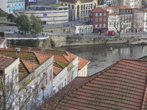 View over red roofs to the river and lively streets with beautiful old buildings in the background,