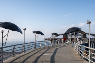 Pier with modern parasols and sea views