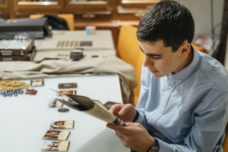 Boy reading boardgame rules playing at home