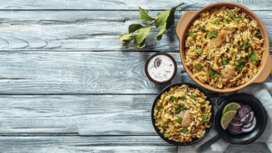 Pakistani food - biryani rice with chicken and raita yoghurt dip. Delicious hyberabadi chicken