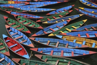 Multi colored rowing boats on Fewa lake, Pokhara