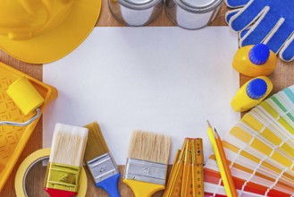 Collection of repair and paint tools on clean sheet of paper construction concept