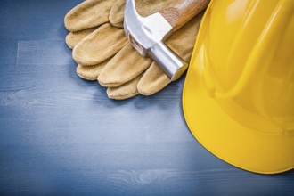 Composition of building helmet claw hammer protective gloves construction concept