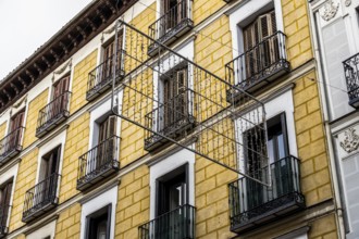 Old residential building against sky. Malasana quarter in Madrid. Real estate and architecture