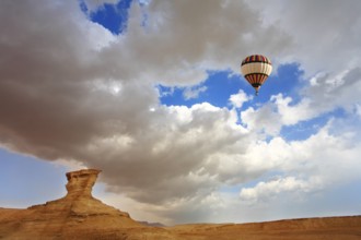 Huge balloon above ancient mountains of the Dead Sea. A sunset