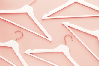 Creative top view flat lay wooden hangers toned living coral color of the year 2019 background copy