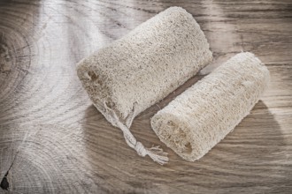 Scrubbing loofah on wooden board top view healthcare concept