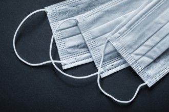 Disposable sterile face masks on black background