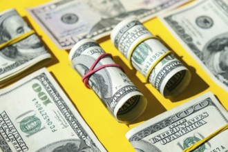 US dollars bundle close up isolated on dollar background. Paper denominations of dollars cash rolls