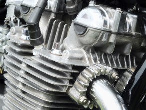 Close up detail of the engine of an old vintage motorcycle with black frame and shiny chrome