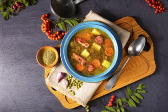 Polish pea soup (grochowka) with smoked bacon and sausage