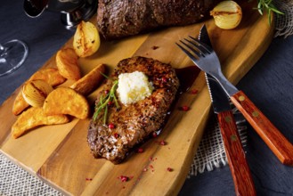 Butter beef steak with herbs and potato wedges