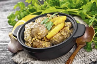 Chicken liver stewed with oranges, sour cream, soy sauce and Provence herbs in a small pan on
