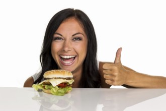 A young woman with a hamburger. Fast food and fast cuisine Austria