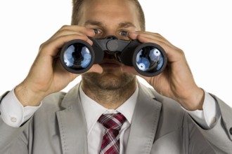 A manager (young entrepreneur) with binoculars looking for orders or jobs Austria