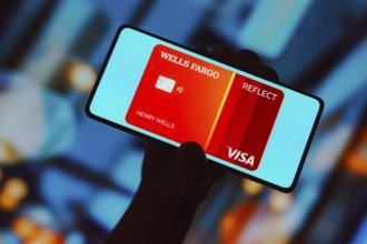 In this photo illustration, the Wells Fargo Reflect Card is displayed on a smartphone screen