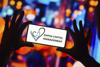 In this photo illustration, the Rapha Capital Management logo is displayed on a smartphone screen