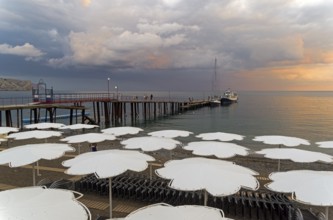View of evening sunset sky from the empty beach of the resort town of Sudak. Crimea