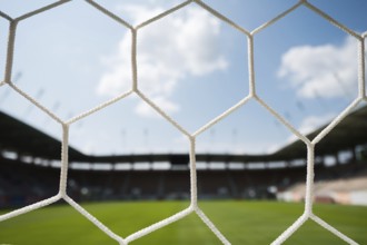 Net on a soccer goal and stadium in the background in Lubin, Poland