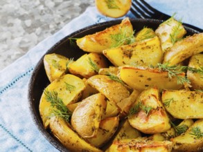 Close up view of backed potatoes in cast iron skillet