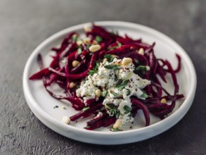 Raw beetroot spaghetti salad with soft cheese, nuts, thyme. Vegetable noodles - Fresh Beetroot