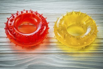 Rubber round hand expanders on wooden board sports training concept