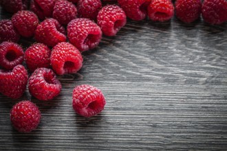 Heap of raspberries on wooden background