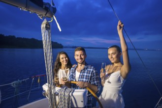 Guy made a trip for the girls on the yacht. Night walk on the boat on the river. Celebration on a