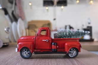 A red retro car with a Christmas tree decorates the festive kitchen for Christmas. Home decor,