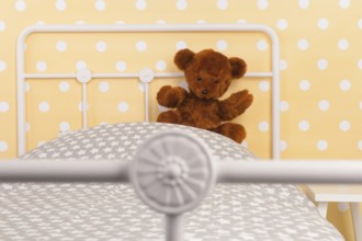 Bedroom with teddy bear sitting on bed
