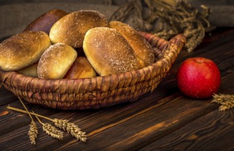 Ukrainian baked pies in wicker basket on wooden table