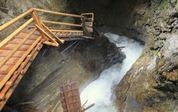 Steep stairs along waterfall and rocks in austria ragaslucht
