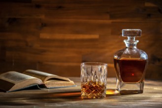 A glass of rum and an old book in a bar in Cuba