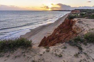 View from one, eroded cliffs of red sand and pebbles with stunning formations illuminated by a warm
