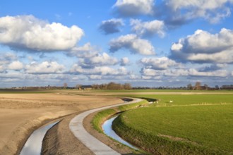 Curved road under blue sky with nice cloudscape, Netherlands