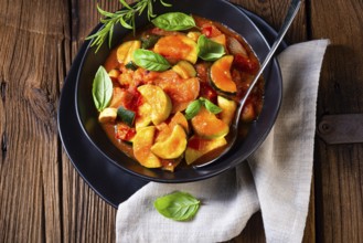 Vegetarian courgette ratatouille with tomato sauce and herbs