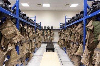 Dressing room of a fighter aircraft (jet fighter) pilot with uniforms and helmets with breathing
