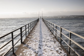A snow-covered jetty stretches far out onto the calm lake, Hörnle, Constance, Lake Constance,