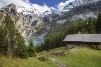 Amazing tourquise Oeschinnensee lake, wooden chalet and Swiss Alps, Berner Oberland, Switzerland