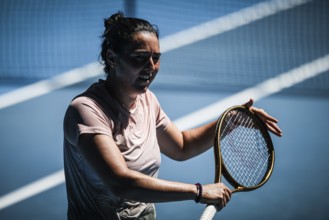 MELBOURNE, AUSTRALIA, JANUARY 12: Ons Jabeur of Tunisia practices with Naomi Osaka of Japan ahead