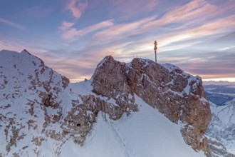 Daybreak on the summit of the Zugspitze with summit cross