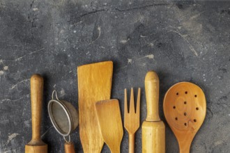 Set of wooden kitchen utensils on a blue background, copy space