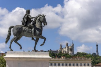 Large equestrian statue of Louis XIV on a pedestal on Place Bellecour and in the background