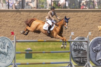 Elena A. Haas, from the United States and riding Claude, compete in the 1.60m Grand Prix during The