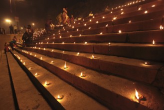 Earthen lamps on staircase to celebrate Dev Deepavali on Ganga River at Varanasi Uttar Pradesh