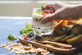 Closeup nutrition yogurt with many fruits on table and chef hand. Food cuisine and drinks concept.