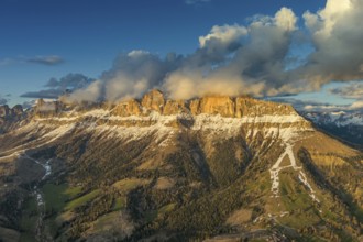 Aerial view of amazing rocky mountains in snow at sunset, Dolomites, Italy